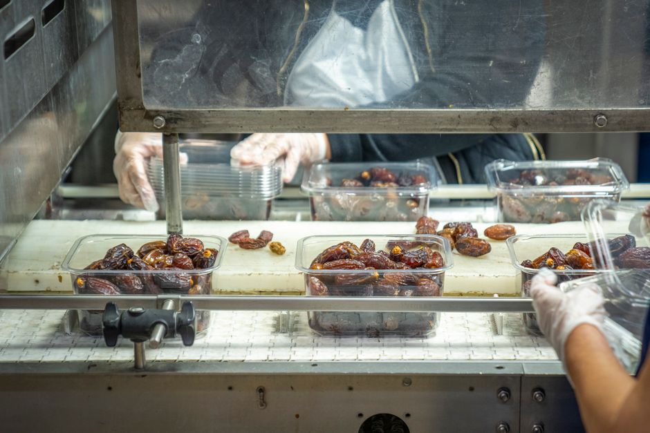 Packing dates being checked on food containers