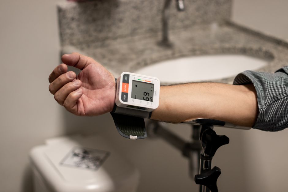 A blood pressure cuff being used to take a reading on someone's arm